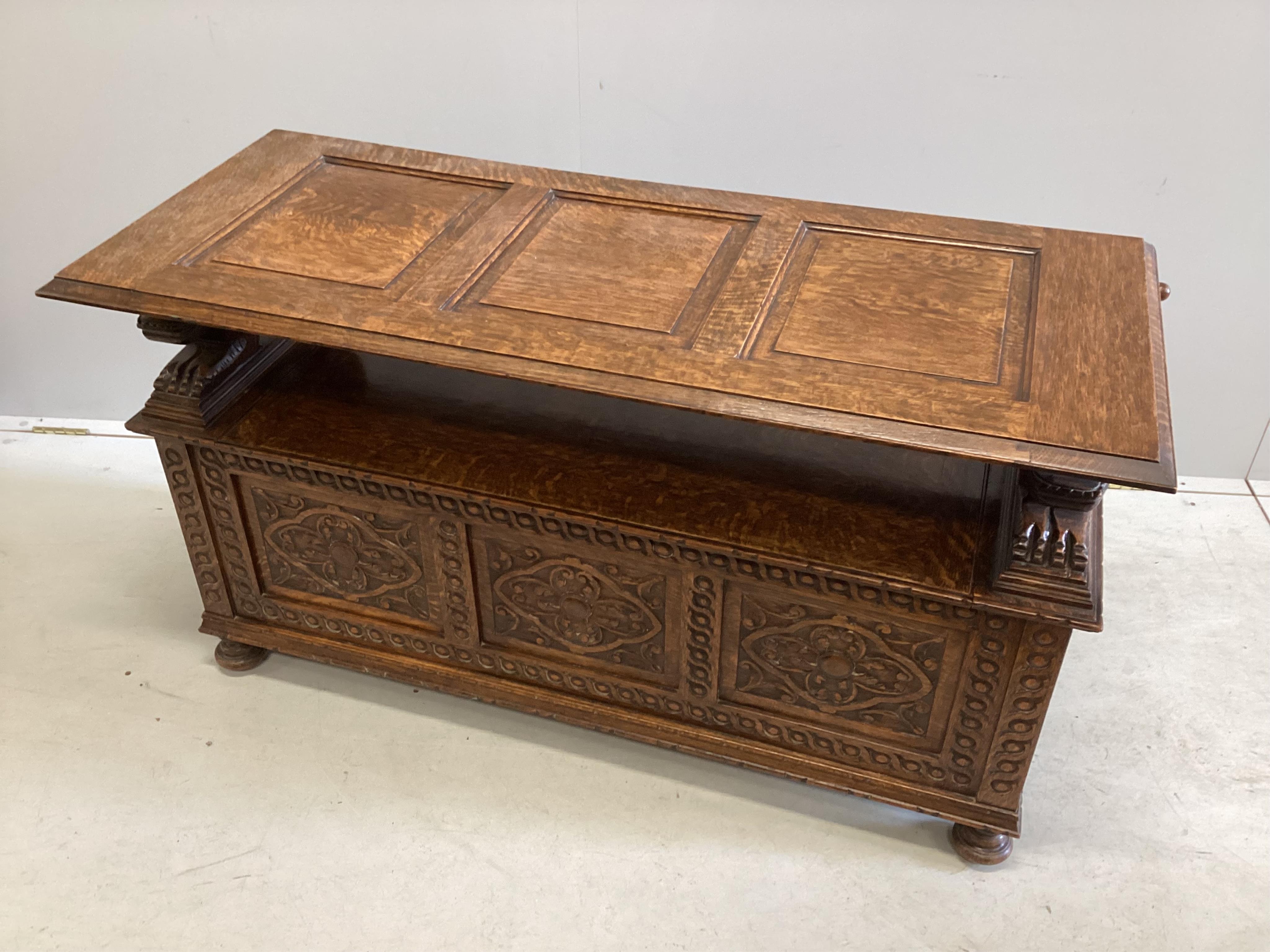 An early 20th century carved oak monk's bench, width 125cm, depth 49cm, height 98cm. Condition - good